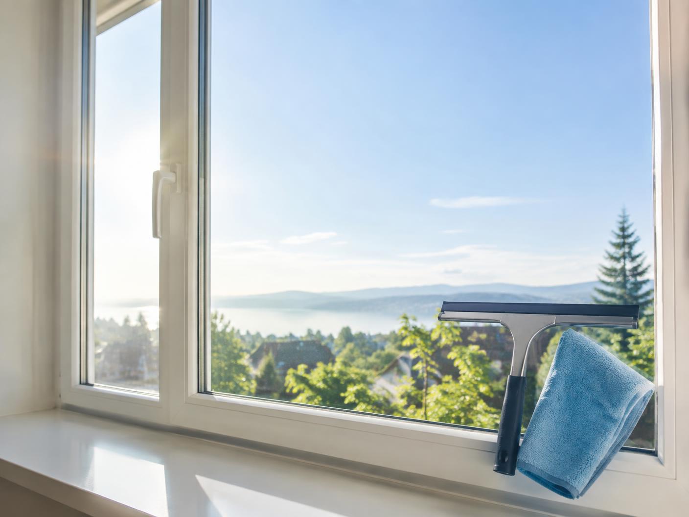 Squeegee and microfiber cloth on a streak-free window
